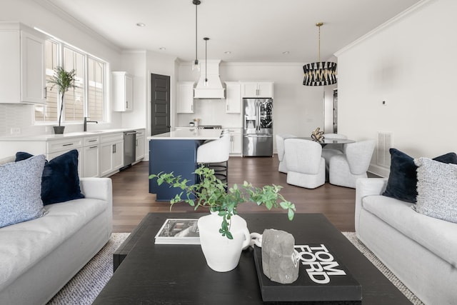 living room with ornamental molding, recessed lighting, visible vents, and dark wood finished floors