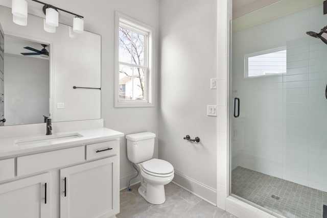 full bathroom featuring toilet, a stall shower, vanity, and a wealth of natural light