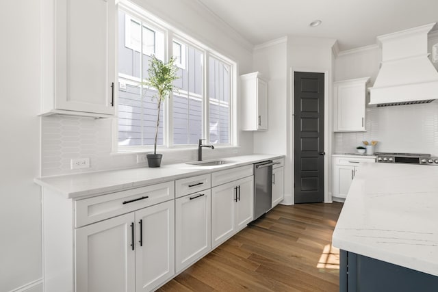 kitchen featuring a sink, white cabinets, stainless steel dishwasher, ornamental molding, and custom exhaust hood