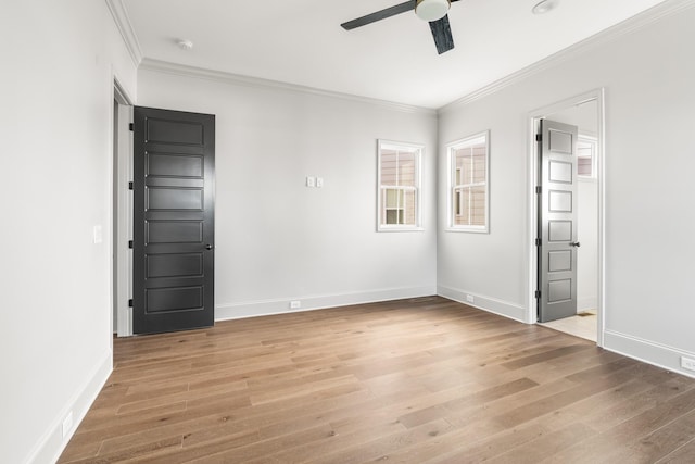 interior space featuring ceiling fan, ornamental molding, wood finished floors, and baseboards