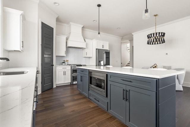 kitchen featuring stainless steel appliances, white cabinets, a sink, and custom exhaust hood