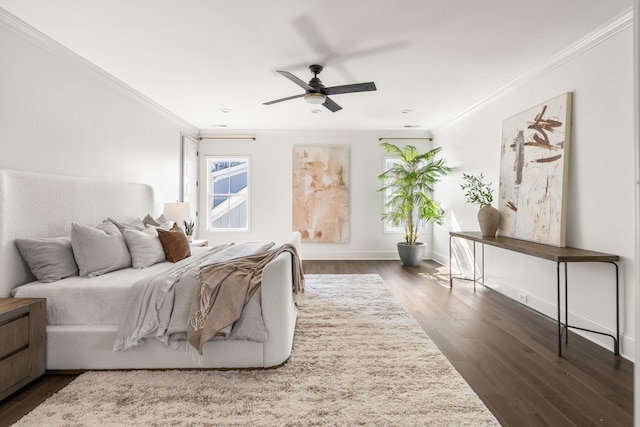 bedroom with dark wood-type flooring, ornamental molding, baseboards, and a ceiling fan