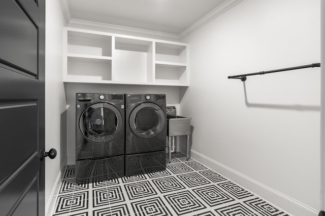 laundry area featuring crown molding, laundry area, baseboards, and washer and dryer