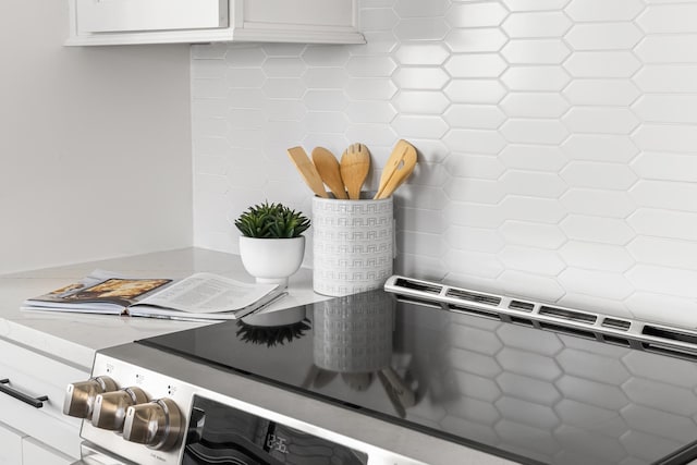 details with rustic walls, white cabinetry, and light stone counters