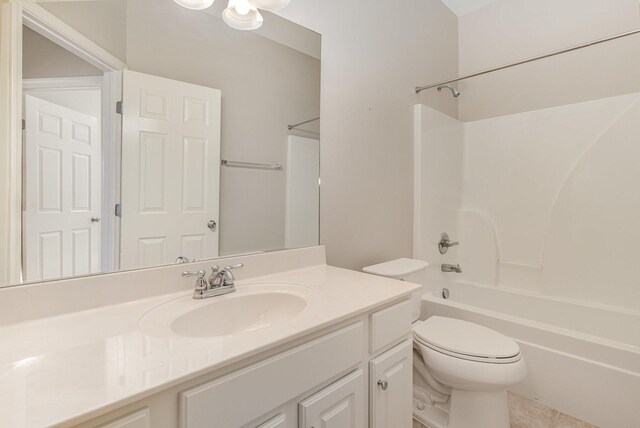 bathroom featuring toilet, tile patterned floors, bathtub / shower combination, and vanity