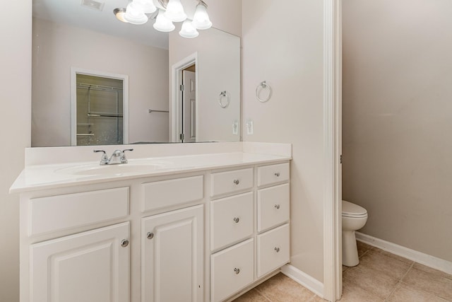 bathroom with tile patterned flooring, toilet, visible vents, vanity, and baseboards