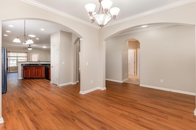 interior space with crown molding, baseboards, dark wood-type flooring, and a sink