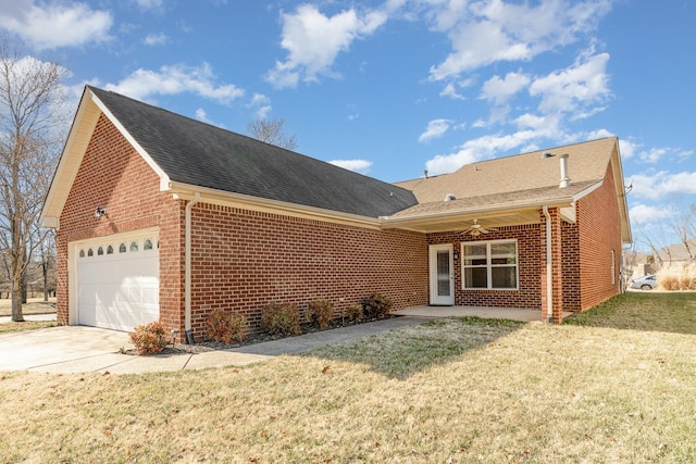 view of front of house with ceiling fan, a garage, brick siding, concrete driveway, and a front yard