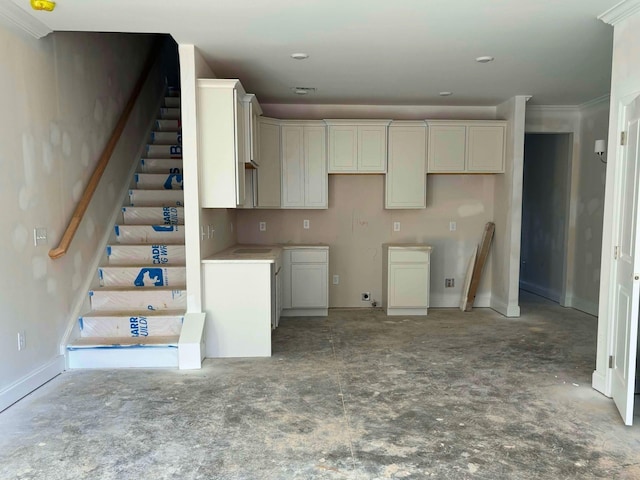 kitchen with ornamental molding and baseboards