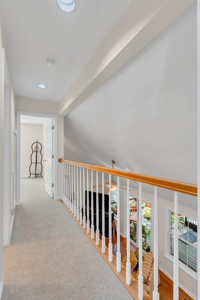 hallway featuring baseboards and recessed lighting