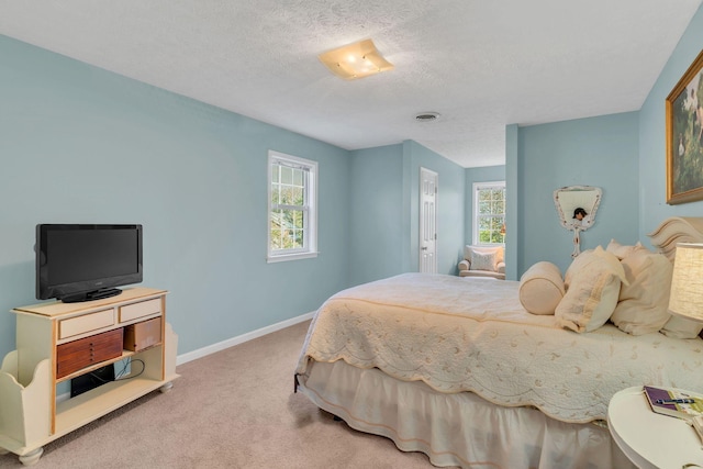 bedroom featuring a textured ceiling, multiple windows, carpet, and baseboards