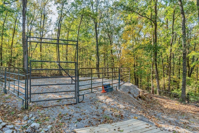 view of gate with a forest view