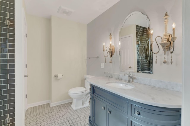 bathroom with baseboards, visible vents, toilet, tile patterned flooring, and vanity