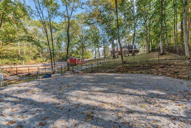 view of yard with fence and an outbuilding