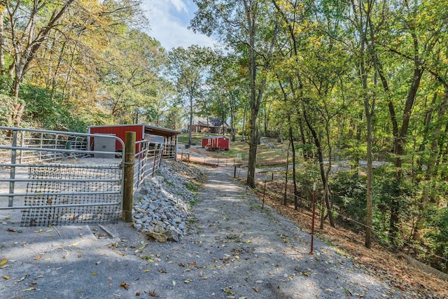 view of gate with an outbuilding and an exterior structure