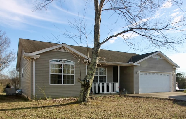 ranch-style house featuring a porch, driveway, and an attached garage