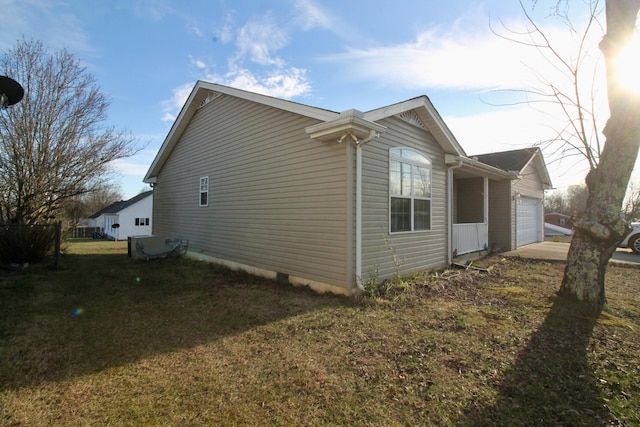 view of side of property with a garage and a yard