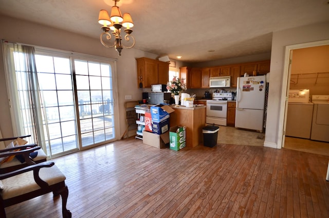 798 Buffalo Valley Rd, Cookeville, TN 38501 - kitchen featuring a peninsula, white appliances, washer and clothes dryer, and light wood-style floors