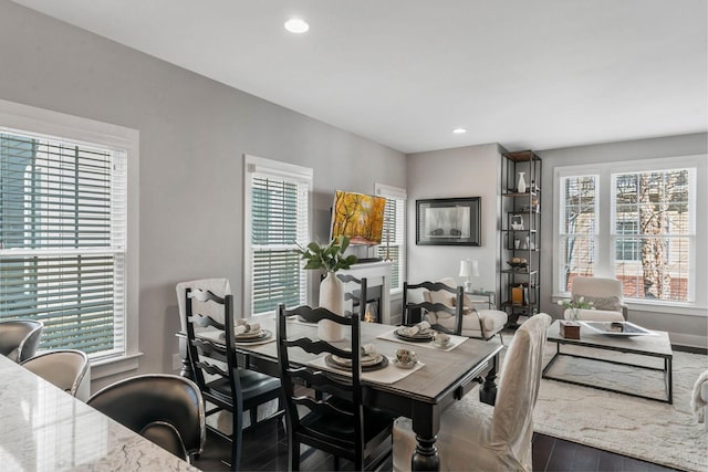 dining area with recessed lighting, baseboards, and wood finished floors