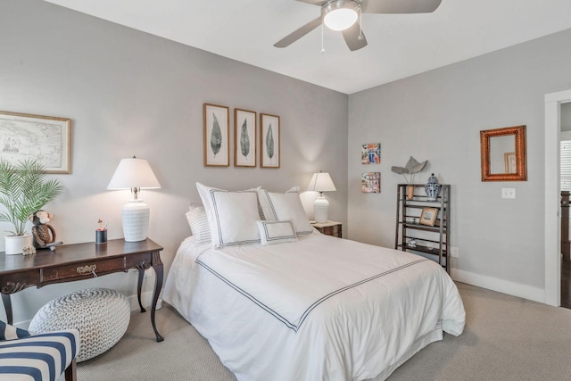 carpeted bedroom with a ceiling fan and baseboards