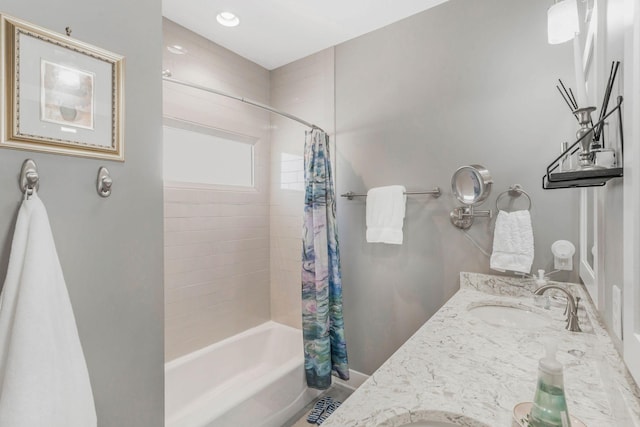 bathroom featuring shower / tub combo and vanity