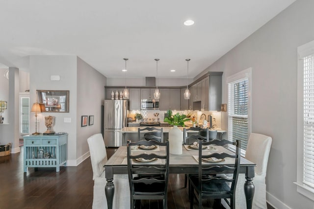 dining space featuring dark wood-type flooring, recessed lighting, and baseboards