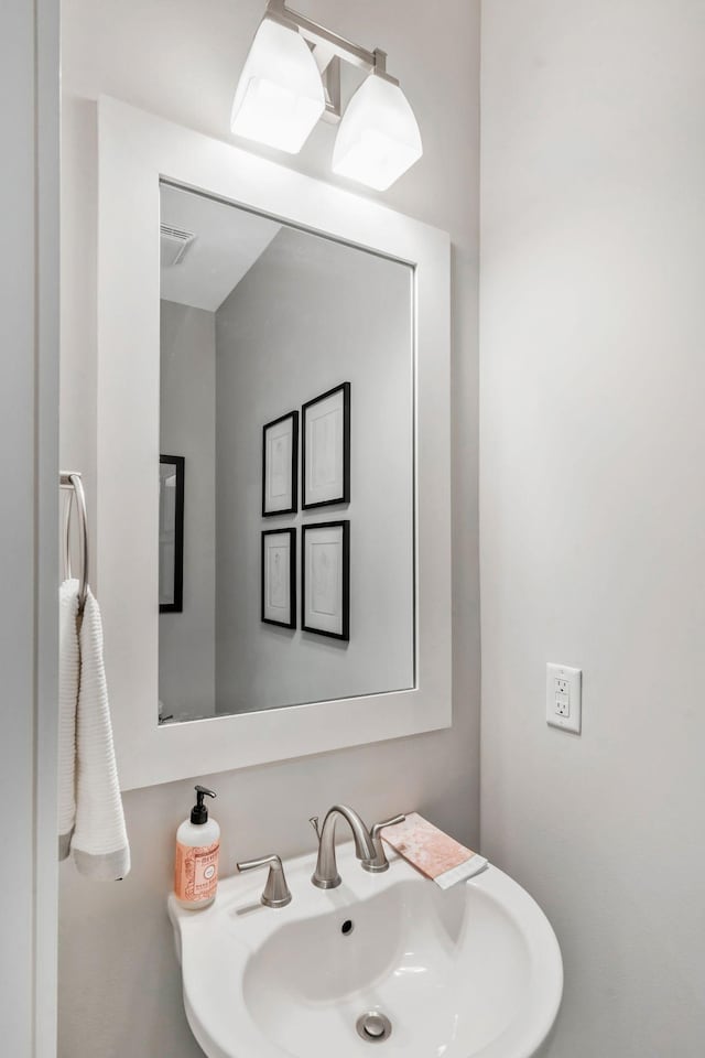 bathroom featuring a sink and visible vents