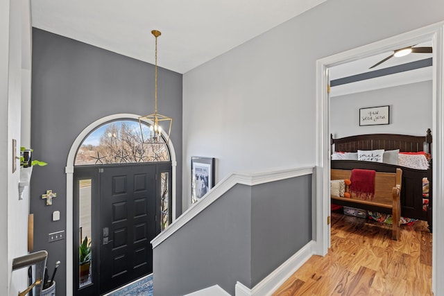 entryway with a chandelier and wood finished floors