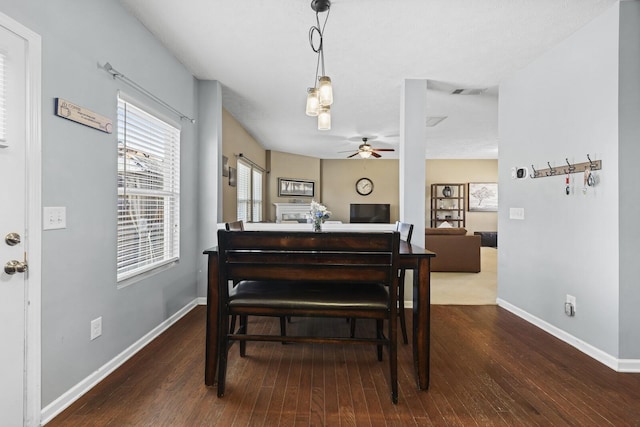 dining area with a ceiling fan, wood finished floors, visible vents, and baseboards