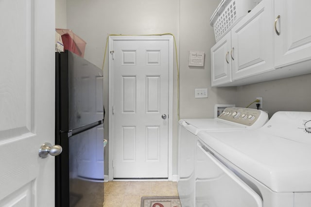 laundry room featuring cabinet space, washing machine and dryer, and tile patterned floors