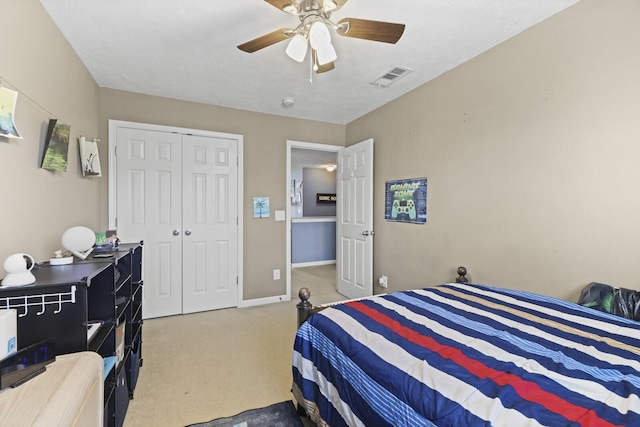 bedroom featuring carpet floors, a closet, visible vents, a ceiling fan, and baseboards