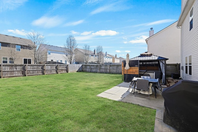 view of yard featuring a residential view, a fenced backyard, a patio, and a gazebo