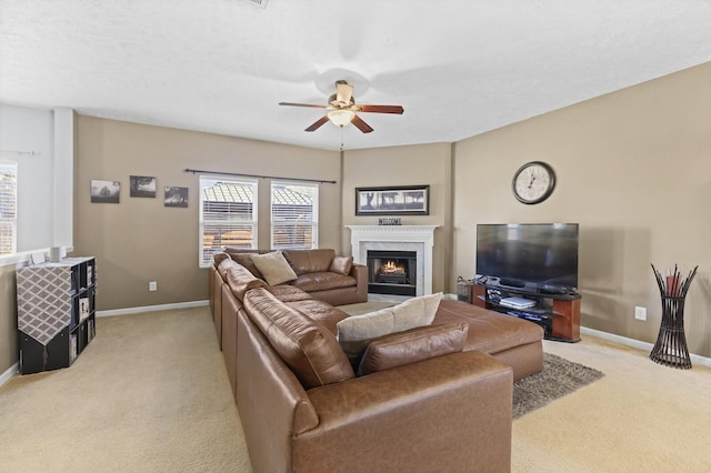 living area featuring light carpet, a premium fireplace, baseboards, and a wealth of natural light