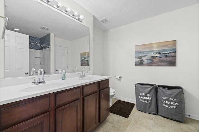 bathroom featuring double vanity, visible vents, walk in shower, and a sink