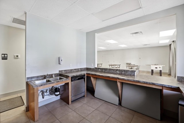 kitchen featuring dark countertops, visible vents, a drop ceiling, and dishwasher