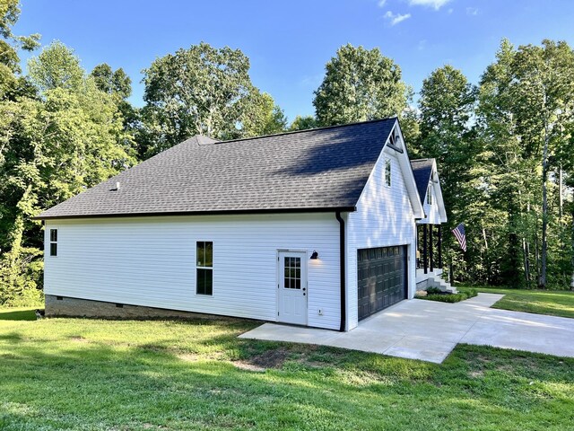 view of side of property featuring crawl space, a shingled roof, and a lawn