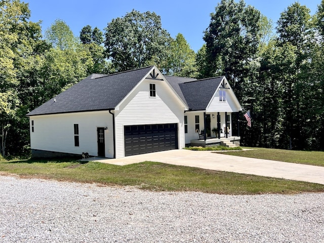 modern farmhouse featuring a garage, covered porch, driveway, roof with shingles, and a front lawn