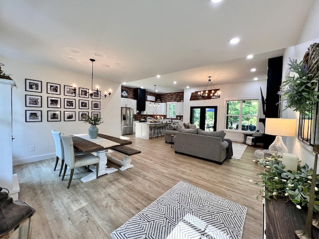 dining room featuring light wood-style flooring, a chandelier, baseboards, and recessed lighting