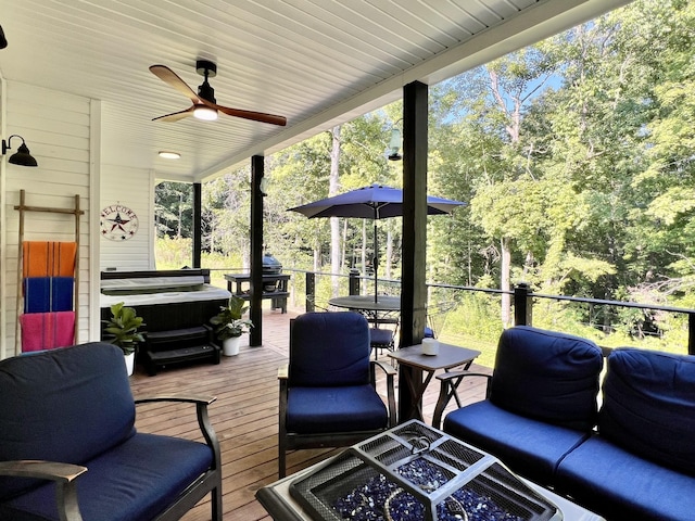 deck featuring an outdoor fire pit and a ceiling fan