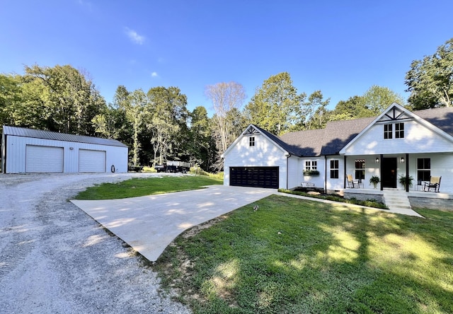 view of front facade with driveway, covered porch, and a front yard