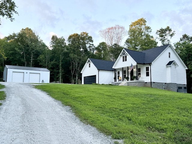 modern inspired farmhouse featuring a porch, crawl space, a detached garage, and a front lawn