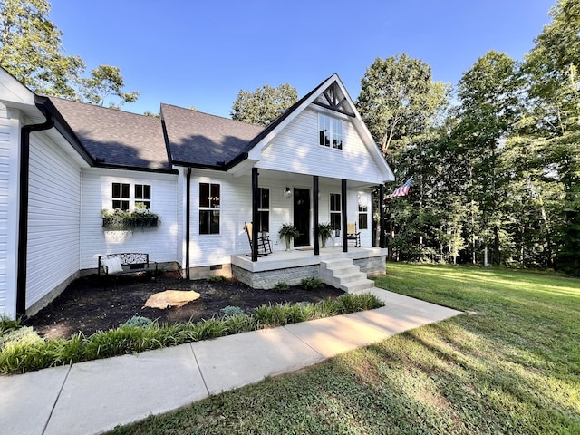 view of front of home with covered porch, roof with shingles, a front lawn, and crawl space