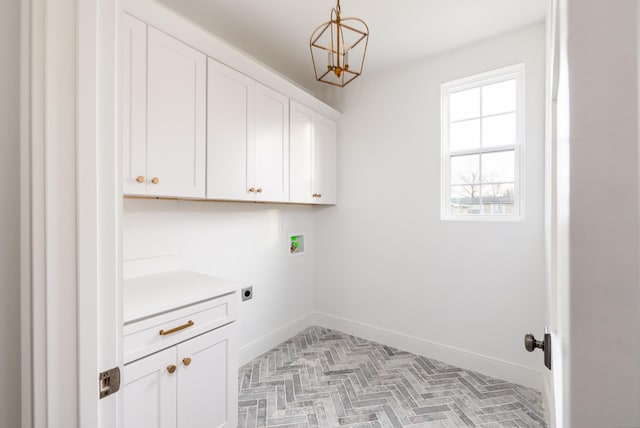 laundry room featuring washer hookup, cabinet space, hookup for an electric dryer, and baseboards