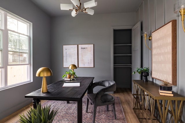 office featuring a notable chandelier and wood finished floors