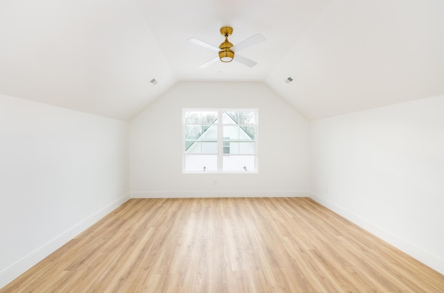 bonus room featuring vaulted ceiling, light wood finished floors, visible vents, and baseboards