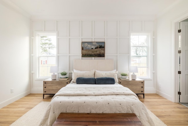 bedroom with baseboards and wood finished floors