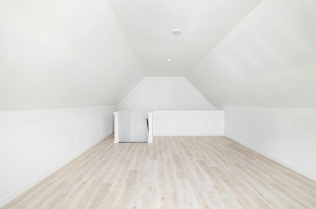 additional living space with lofted ceiling and light wood finished floors