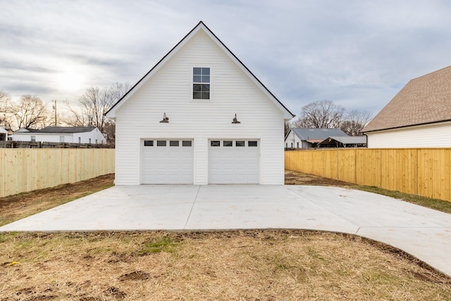 garage with a garage and fence