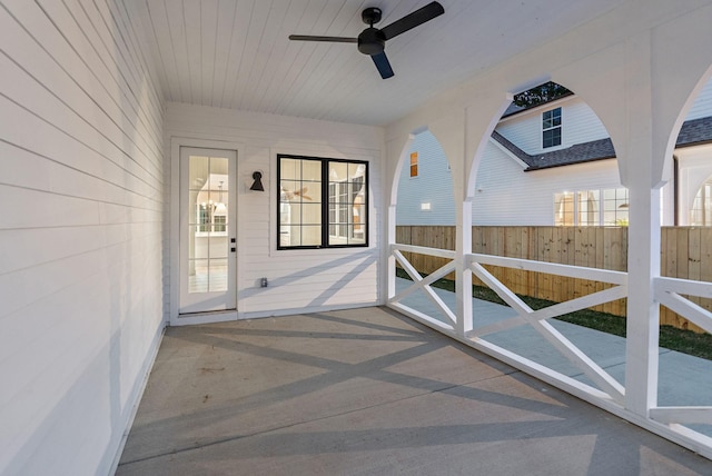 unfurnished sunroom with ceiling fan