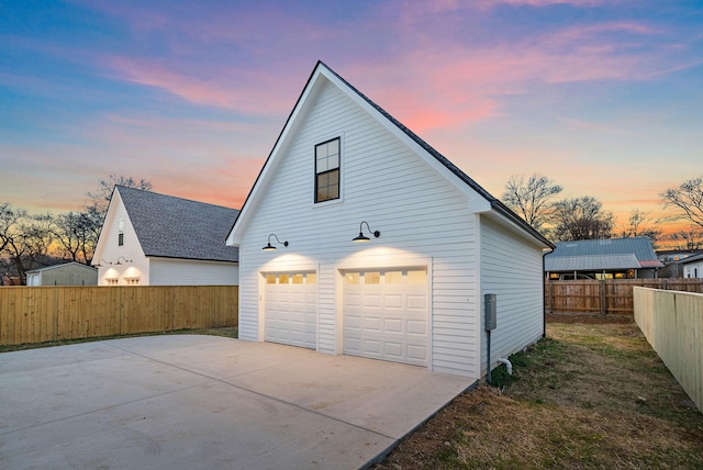 view of side of property featuring an outbuilding and fence private yard